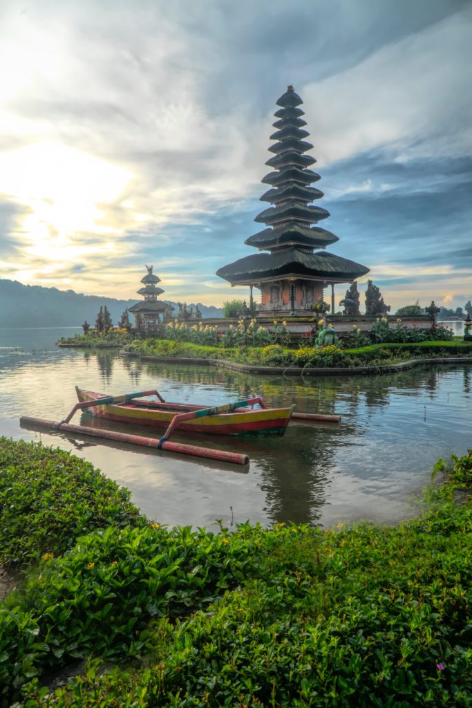 canoe-on-body-of-water-with-pagoda-background-2166559