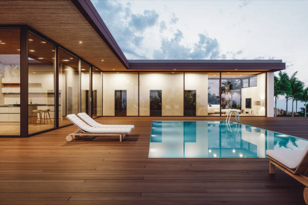 Modern luxury villa with private swimming pool at dusk.